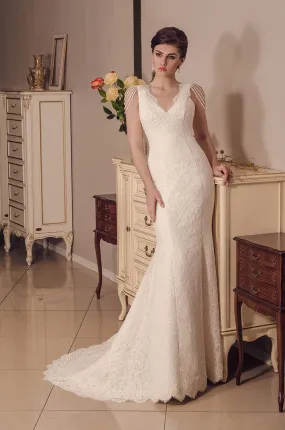 ---Mermaid wedding dress made of satin and lace with embroidered straps and decorated with dangling jewels--